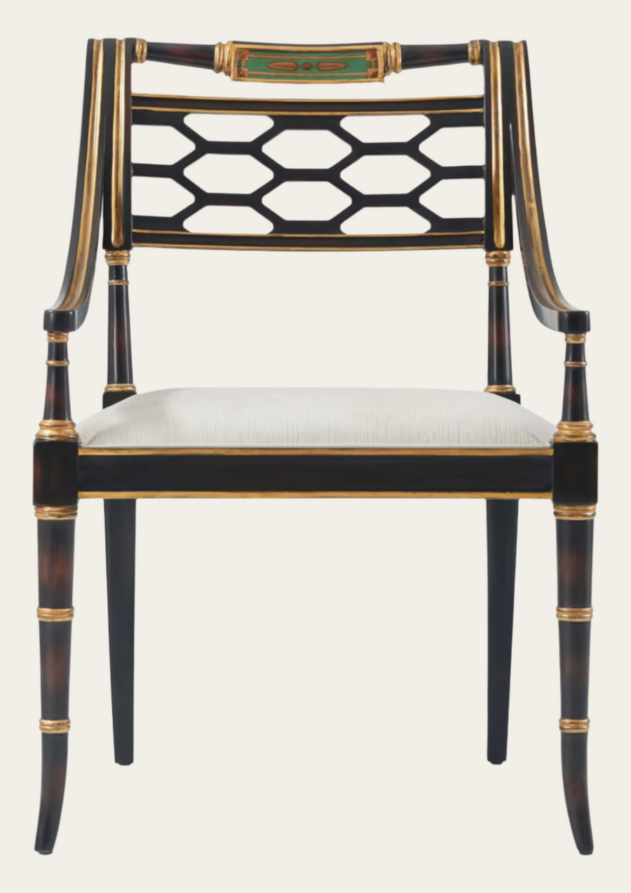 Decorative chair with black and gold lattice backrest on a white background
