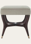 Beige upholstered stool with dark wooden legs on a white background