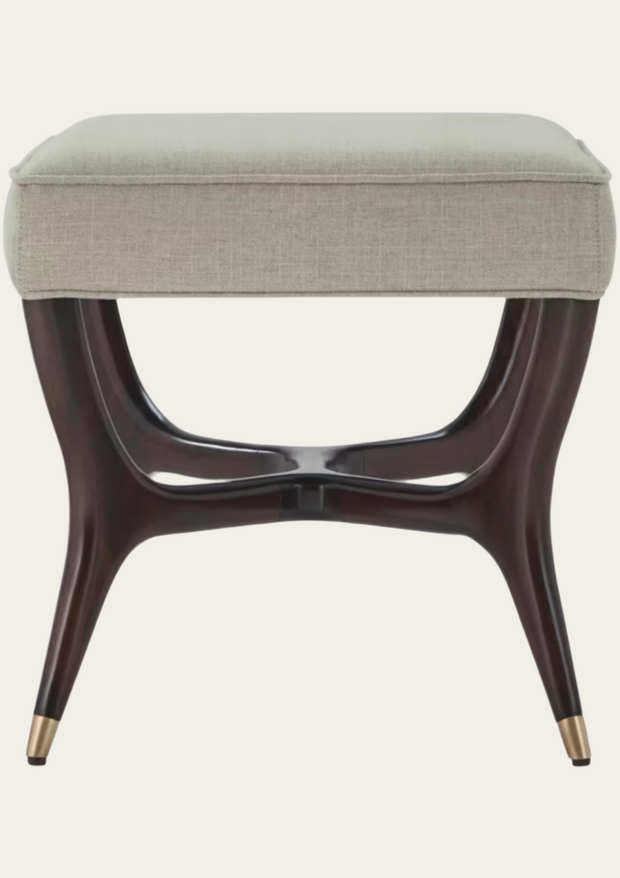 Beige upholstered stool with dark wooden legs on a white background